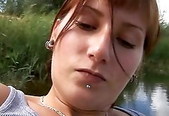 Horny teenager enjoys petting her coochie near the lake...